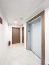 Hall featuring light marble finish flooring and elevator