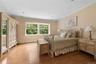 Bedroom with crown molding and light wood finished floors