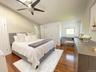 Bedroom featuring dark wood finished floors, lofted ceiling, and ceiling fan