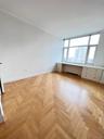 Empty room with built in study area and ornamental molding