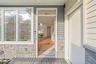 Entrance to property featuring stone siding