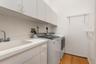 Interior laundry room with washer, dryer, and utility sink.