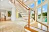 Stairs featuring recessed lighting, a towering ceiling, and inlaid floor details