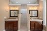 Primary bathroom featuring dual showers