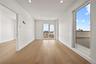 Empty room with light wood-style floors and recessed lighting