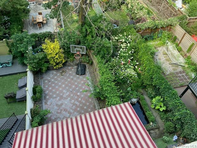 Backyard with covered terrace  & basketball hoop