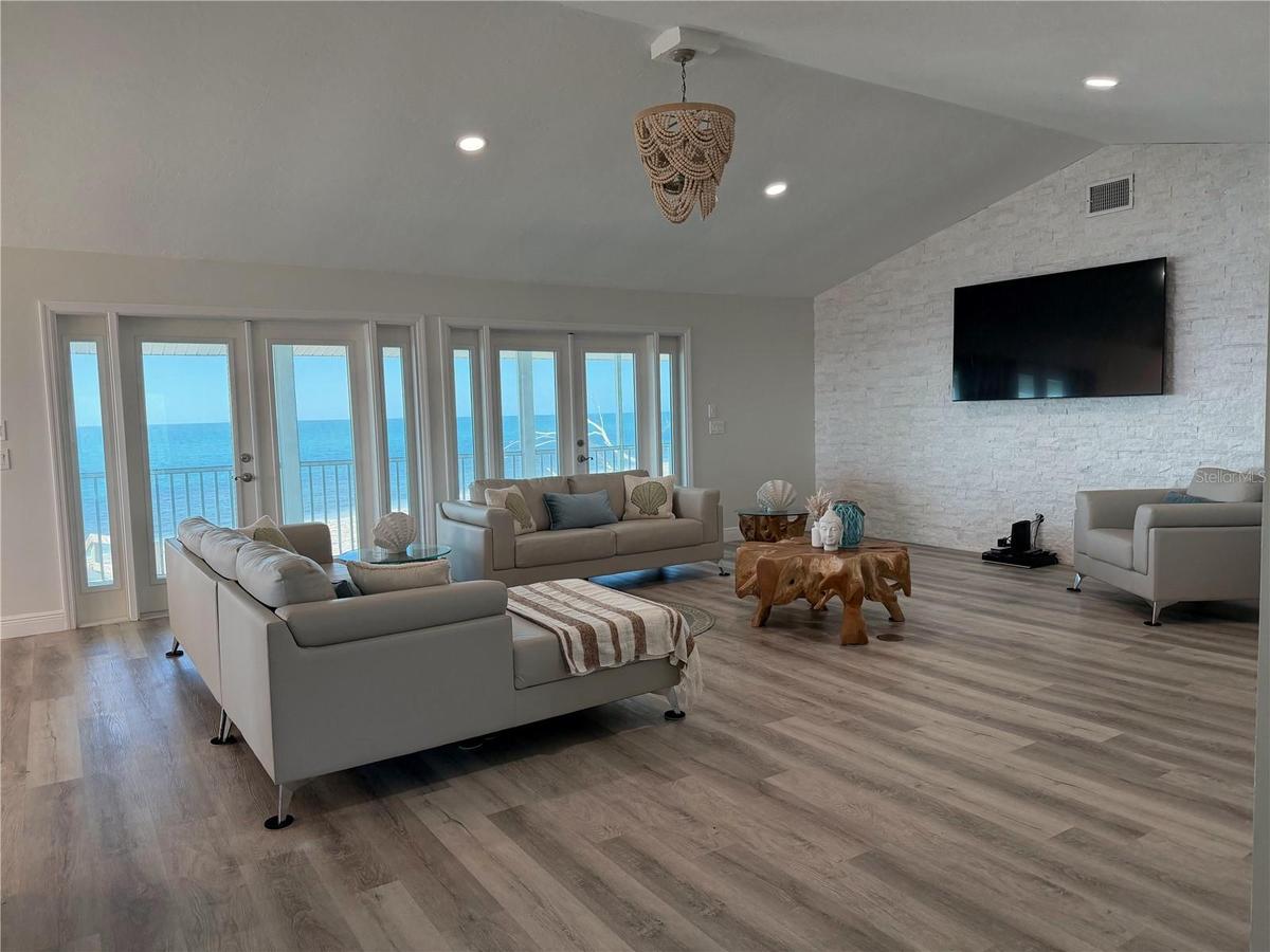 Living area with French doors opening to the Gulf-view covered porch.
