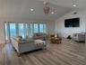 Living area with French doors opening to the Gulf-view covered porch.