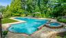 L-Shaped tiled gunite saltwater gas heated pool, with attached circular in-ground spa