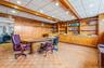 Office area with wood walls, recessed lighting, and beam ceiling