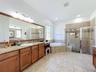 Dual vanities , step in shower and tub in this primary suite