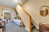 Stairs to top floor and spacious bedroom.