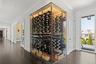 Wine cellar with wood finished floors, ornamental molding, and baseboards