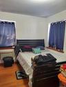 Bedroom with wood finished floors and a wall mounted AC