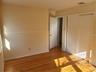 Unfurnished bedroom with visible vents, light wood finished floors, baseboards, and a closet