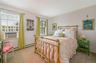Bedroom featuring baseboard heating, cooling unit, and carpet flooring