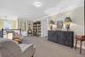 Sitting room with carpet flooring, crown molding, and an upstairs landing