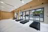 Workout area featuring wooden walls and marble finish floors
