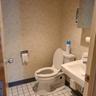Half bathroom featuring tile patterned floors, a sink, toilet, and baseboards