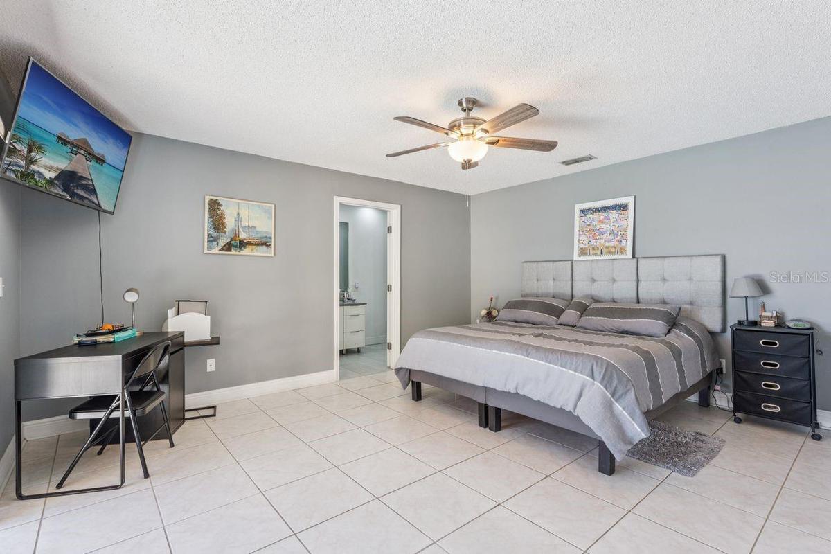 Primary bedroom with view of pool