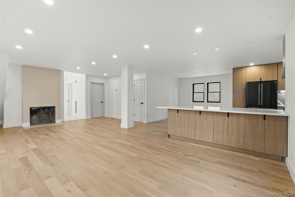 Expansive open-concept living area featuring light wood-finish flooring