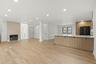 Expansive open-concept living area featuring light wood-finish flooring