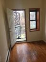 Entryway with hardwood / wood-style flooring, baseboards, and baseboard heating