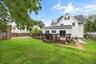 Backyard – Spacious backyard featuring a large wood deck, expansive lawn, and mature trees that provide a welcoming outdoor setting. Offering plenty o