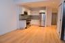 Kitchen featuring appliances with stainless steel finishes, white cabinetry, modern cabinets, backsplash, and light wood-style floors