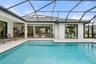 Elegant water features create a tranquil ambiance, filling the lanai with the soothing sounds of cascading water and enhancing the peaceful outdoor re