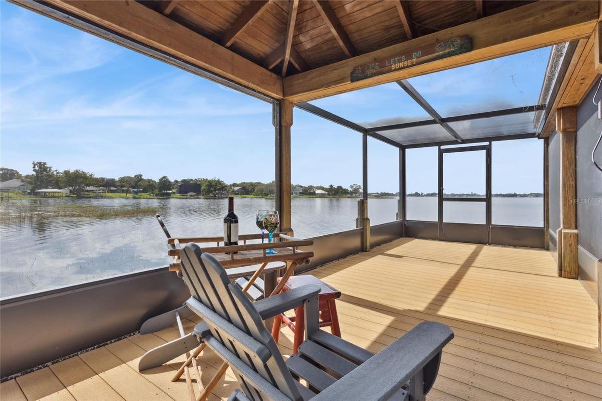 Enclosed screen room on boat dock