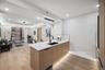 Kitchen with a sink, modern cabinets, light wood-style flooring, a peninsula, and open floor plan