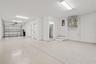Extended 2 car tandem garage with storage room and upgraded flooring