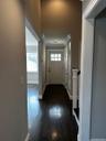 Entrance foyer with crown molding and wood finished floors