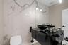 Bathroom with stone wall and marble tiled flooring