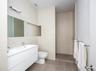Bathroom with double vanity, tile walls, and a walk in shower