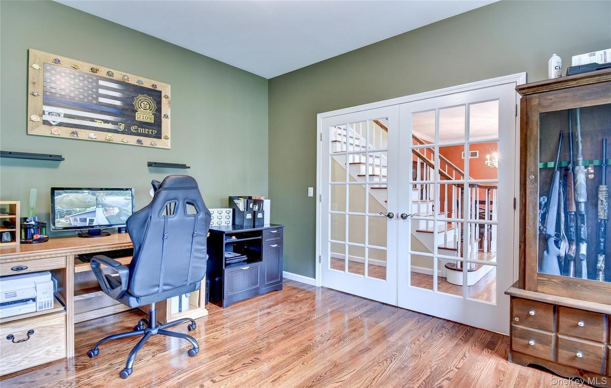 Office with wood flooring and french doors