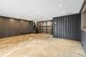 Below grade area featuring recessed lighting, stairway, and stone finish flooring