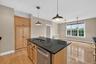 The large kitchen island provides extra prep space, storage, and an easy place to gather while meals are being made.
