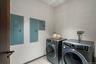 Washroom featuring laundry area, electric panel, light tile patterned floors, and independent washer and dryer