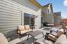 Wooden terrace with an outdoor hangout area and grilling area