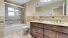 Full bathroom featuring toilet, a sink, tile walls, visible vents, and tile patterned flooring