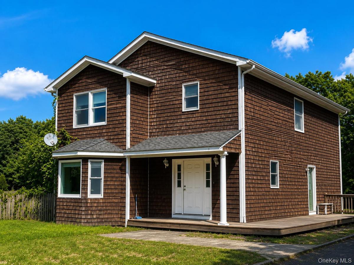 Two-story residence featuring cedar shake siding, a bay window, and a covered entry porch ( Ai enhanced)