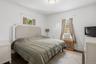 Bright primary bedroom facing the backyard (#222)