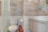 Bathroom featuring vanity and tile walls