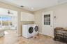 Washroom with a ceiling fan, baseboard heating, washing machine and clothes dryer, and recessed lighting