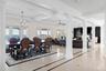 Dining area featuring ornate columns, crown molding, a chandelier, inlaid floor details, and coffered ceiling