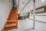 Stairs with a wainscoted wall, recessed lighting, tile walls, and tile patterned floors