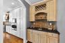 Butler's pantry with storage and extra entertaining space between kitchen/dining room
