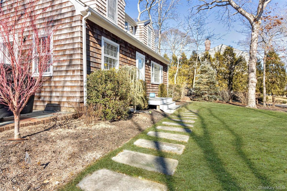 View of side of property featuring a yard